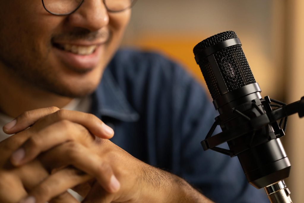 A close up of a man speaking into a mic - to represent Nerve Strategic's Media Training