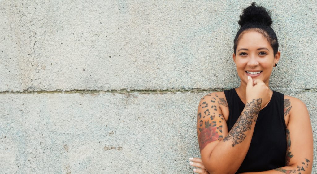 Young female entrepreneur with cement background - representing The Edge online training program